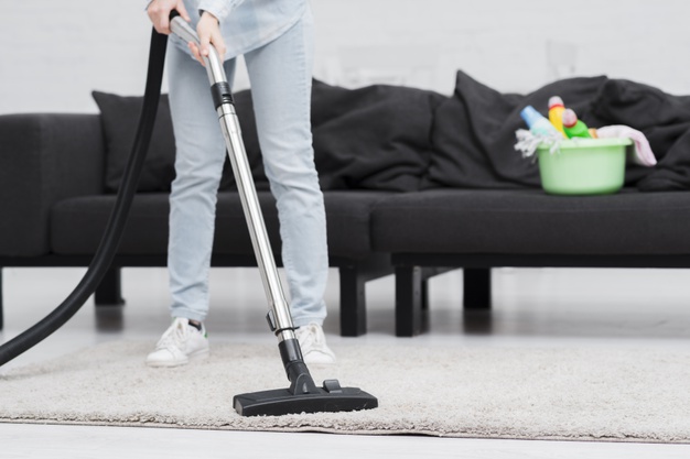 close-up-woman-cleaning-with-vacuum-cleaner_23-2148394900